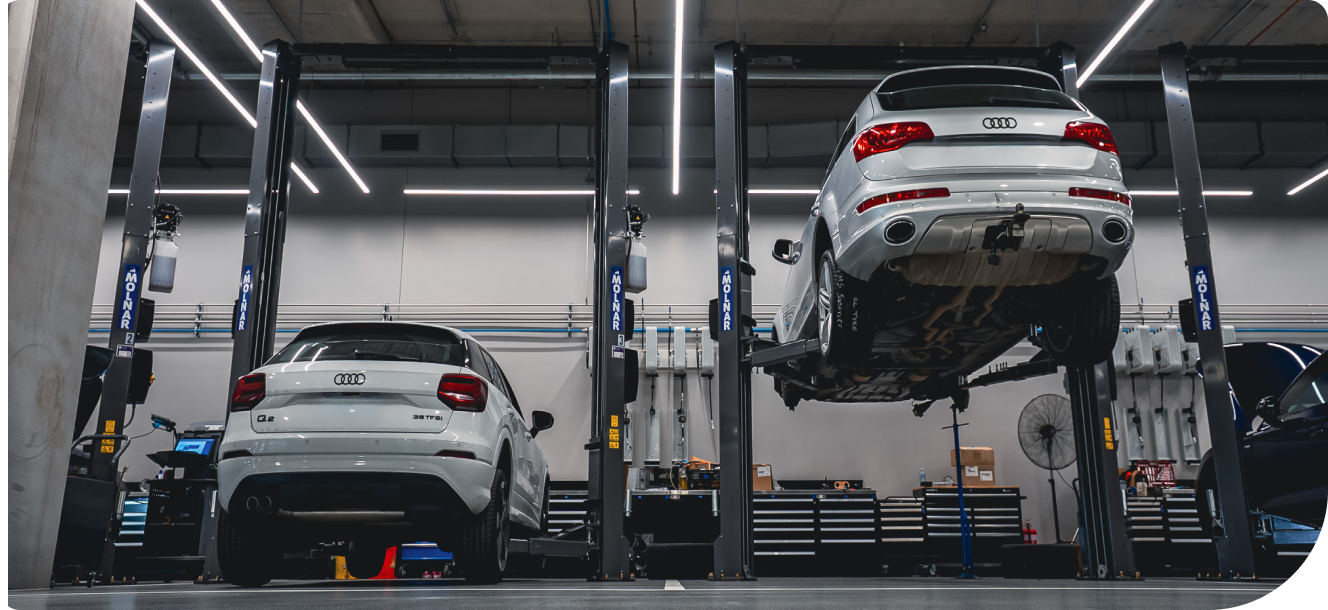 Automotive workshop with multiple vehicles on 2-post hoists