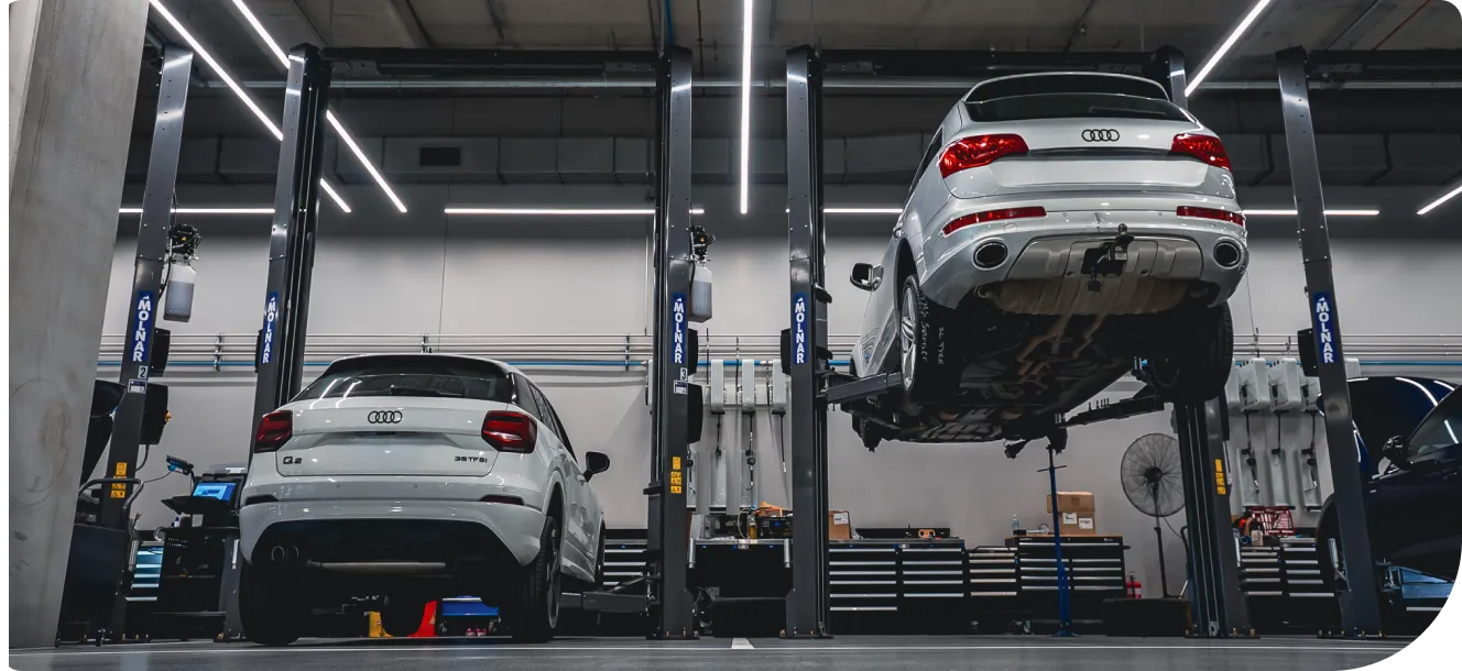 Automotive workshop with multiple vehicles on 2-post hoists